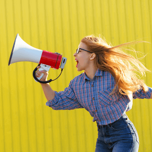 A girl speaks through a bull horn