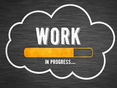 Work-in-progress-written-out-on-a-black-background-in-chalk-with-a-cloud-around-it-and-a-bright-yellow-progress-bar
