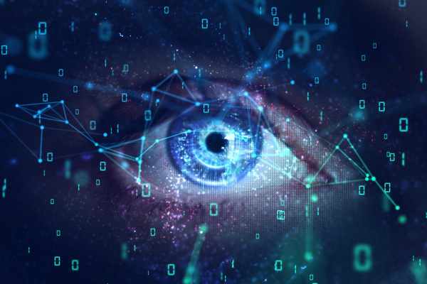 a blue eye with computer data - 0s and 1s - filtered over it like a computer screen