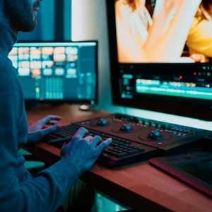 a man at his computer working on a video