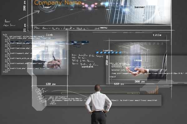 a man staring at a large screen with a website index, website code, and the layout of a website