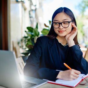 a-lady-with-glasses-watching-a-video-on-her-laptop