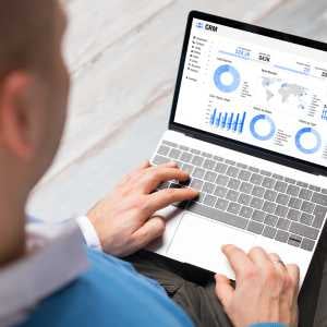 a-man-with-a-laptop-on-his-lap-screen-displays-graphs-and-charts