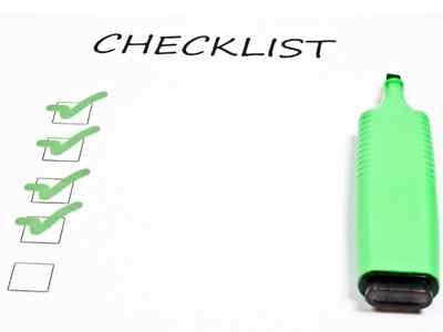 a-pice-of-paper-with-checklist-written-on-it-and-boxes-that-are-checked-and-unchecked-and-a-green-highlighter-sitting-on-the-paper