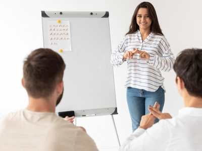 lady-in-front-of-a-whiteboard-communicating-with-two-menu-using-sign-language-1