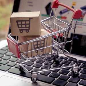 laptop-with-mini-shopping-cart-on-it-with-packages-in-the-cart