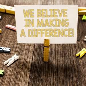 we-believe-in-making-a-difference-sign-being-held-up-by-a-clothespin