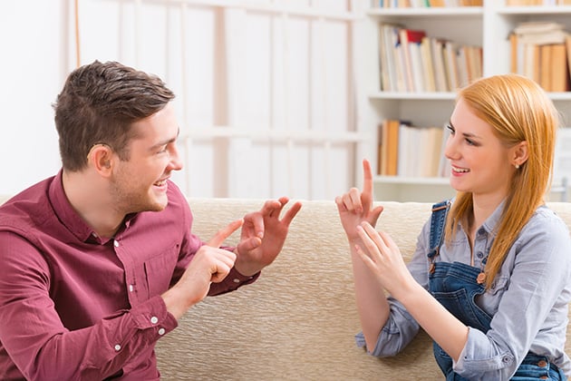 Man and woman using sign language in their conversation